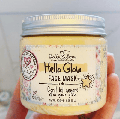 Bella and Bear Hello Glow face mask jar of yellow cream with silver lid floral label Dont let anyone dim your glow 200ml