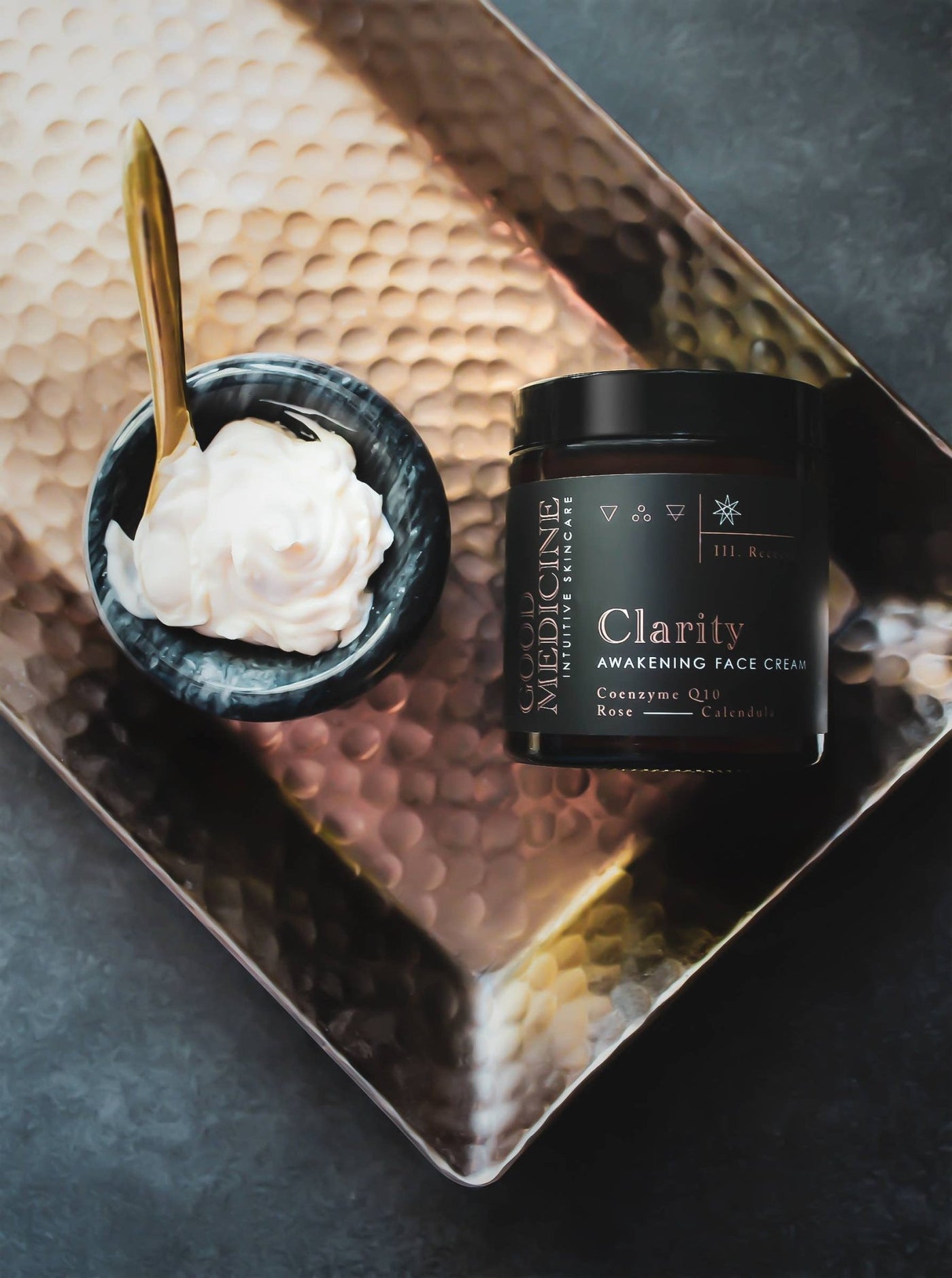 Good Medicine Beauty Lab Clarity jar and bowl of cream on hammered tray with gold spoon awakening face cream