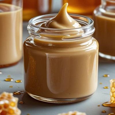 Beautique Goals glass jar of creamy beige facelift cream with manuka honey beside honeycomb and drips